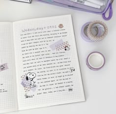 an open notebook with stickers and tape on it next to some other items such as washi tapes