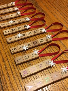 wooden scrabbles with snowflakes are lined up on a table