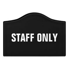 a black sign that says staff only