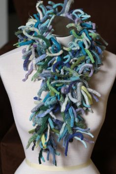 "The Ocean Blue Boa scarf is perfect for those who enjoy the practical as well as the whimsical.  It's practical in that it will keep you oh-so-warm-and-toasty.  The multi-directional strips of wool made from the seams of felted sweaters reach out in every direction to trap warm air and hold it close to your body, insulating you from the cold temps.  It's whimsical because...it's a boa, and let's face it, who doesn't feel glamorous in a boa?  Practicality + Whimsy = the warmest and most unique s Handmade Wool Scarf, Turquoise Scarf, Recycled Sweater, Merino Wool Scarf, Ribbon Yarn, Upcycle Sweater, Felted Scarves, Blue Scarf, Custom Earrings