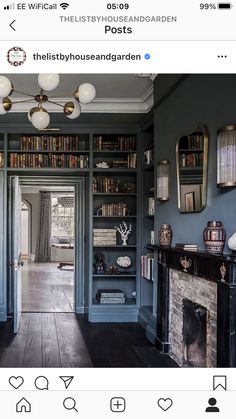 an instagram photo of a living room with bookshelves and fireplace