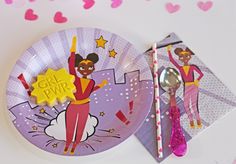 a paper plate with a cartoon character on it next to a spoon, fork and napkin