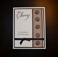 a greeting card with an animal paw print on the front and bottom, saying sorry for the loss of your beloved pet