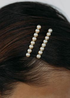 The Gracie Bobby Pins are a wardrobe staple. This set of two features rows of hand bezel-set Swarovski pearls, for a sweet yet sophisticated finishing touch. When it comes to bobby pins, more is more: don't be afraid to layer on multiple sets, or mix with the Gwen Bobby Pins and Perla Bobby Pins. Product Details Hand bezel-set Swarovski pearls. Steel bobby pins. Made in the USA. Care Instructions Store in dust bag. Avoid contact with water, perfume, and other chemicals, including hairspray, whic Diamond Hair Slides, Diamante Hair Pins, Pearl Bobby Pins Hairstyle, Pearl Hairstyles, Pearl Bobby Pins, Pearl Hair Accessories, Birthday Pics, Luxury Hair Accessories, Prom 2023