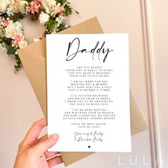 a person holding up a card with the words daddy written in cursive writing