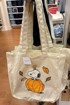 a white bag with a snoopy pumpkin on it's front and back side