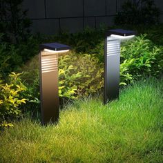 two modern outdoor lights in the grass