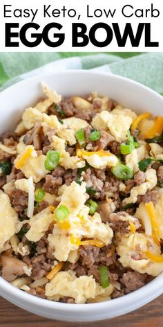 an egg bowl with meat and vegetables in it on top of a wooden table next to a green towel