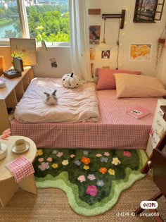 a dog is sitting on the bed in this small room with a large window looking out at the city