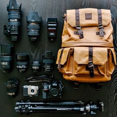 many different types of cameras and equipment on a table