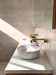 a bathroom sink sitting on top of a white counter