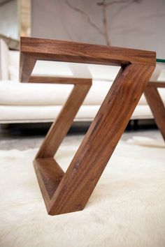 a wooden table sitting on top of a white rug