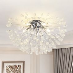 a chandelier hanging from the ceiling in a living room