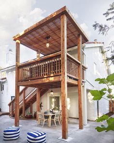 an outdoor patio with wooden furniture and stairs