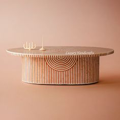 a round table with candles on it in front of a pink background that says luxury handcrafts