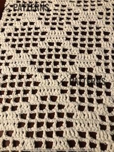 a crocheted tablecloth with holes in the middle and words written on it