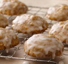 glazed donuts on a cooling rack with icing drizzled over them