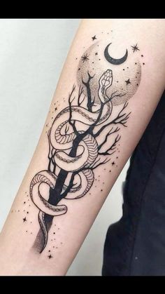 a woman's arm with a snake and dagger tattoo on it