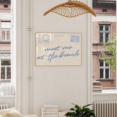 a living room filled with furniture and a painting on the wall next to a window