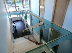 an aerial view of a staircase with glass railings