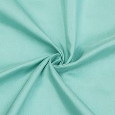 a close up shot of the fabric in aqua green color, with very soft folds