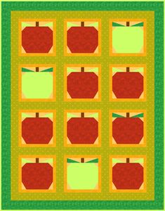 an apple quilt is shown with green and yellow squares on the bottom, and red apples in