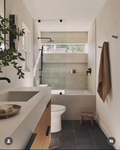 a bathroom with a toilet, sink and shower