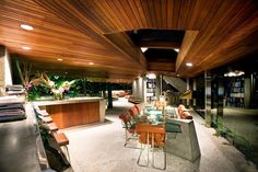 a dining room table and chairs in front of a bookshelf