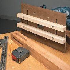 a workbench with tools on top of it and a cordless driller in the background