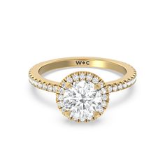 a yellow gold engagement ring with a round diamond center