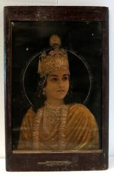 an old framed portrait of a woman in gold