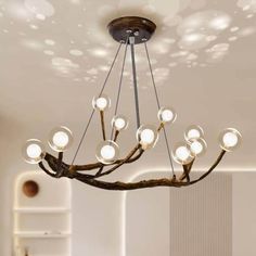 a chandelier hanging from the ceiling in a room with white walls and flooring