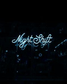 a neon sign that says night shift in the dark