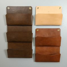 three different types of leathers hanging on the wall next to each other, one brown and one tan