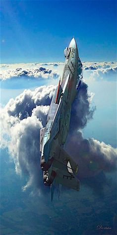 a fighter jet flying through the sky above clouds