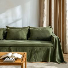 a living room with a green couch and coffee table