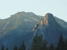 the mountains are covered in snow and trees