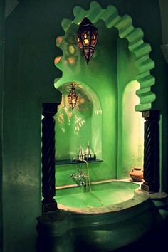 a bath room with a sink and a mirror on the wall next to an archway