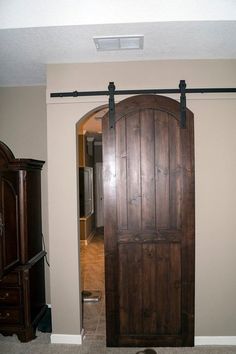 an open wooden door in the middle of a room