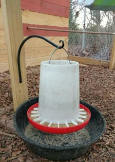 a bird feeder that is sitting in the dirt