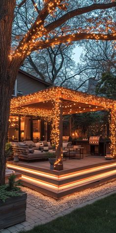 an outdoor covered patio with christmas lights on the trees