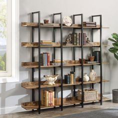 a bookshelf in the corner of a room next to a potted plant