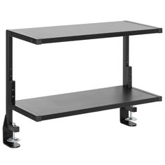 a black shelf sitting on top of a white wall next to a pair of wheels