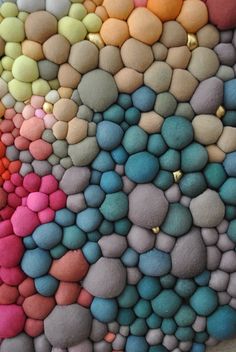 there are many different colored rocks on the wall