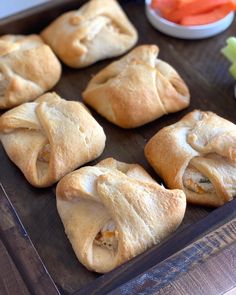 several pastries on a tray with carrots and celery