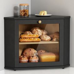 a black cabinet filled with bread and pastries