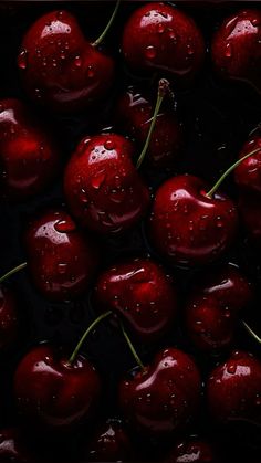 some cherries with water droplets on them