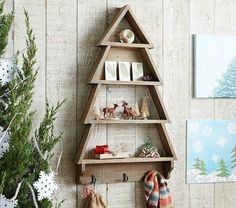 a wooden christmas tree shelf with stockings hanging from it's sides next to a small christmas tree