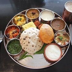 a plate filled with different types of food on top of a table next to silverware