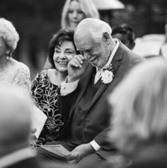 a man and woman sitting next to each other at a wedding